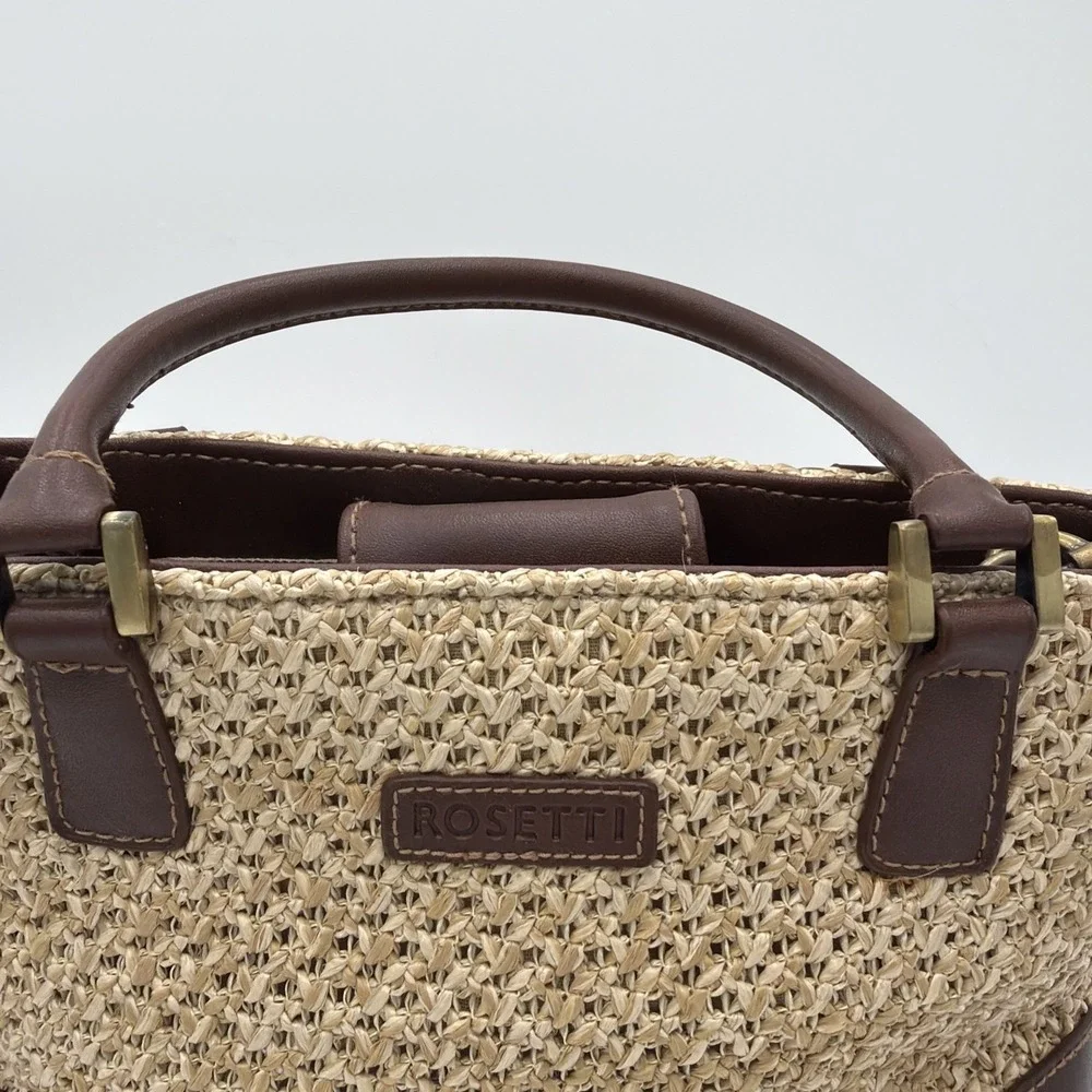 Rosetti straw tote handbag with brown faux leather trim‎ and top handles.